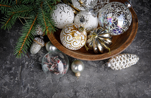 Christmas decoration for firtree glass balls on old wooden board in rustic style. Greeting card with copyspace top view