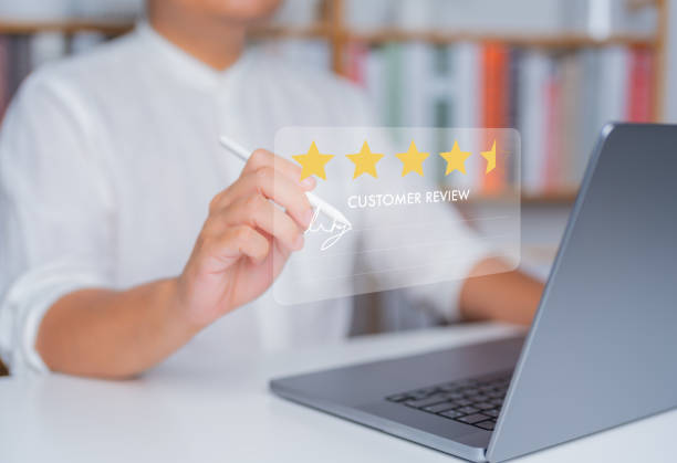 istock Customer satisfaction survey concept. Client uses laptop computer and pen to write customer review. Satisfied, 5 stars service experience rating, Online application satisfaction review best quality. 1705585259