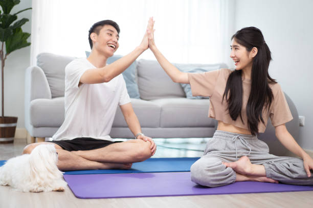 istock Asian lovely couple doing a home exercise with a dog. 1705586824