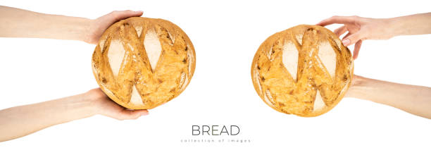 istock Freshly baked round bread in hand isolated on white background 1705588569