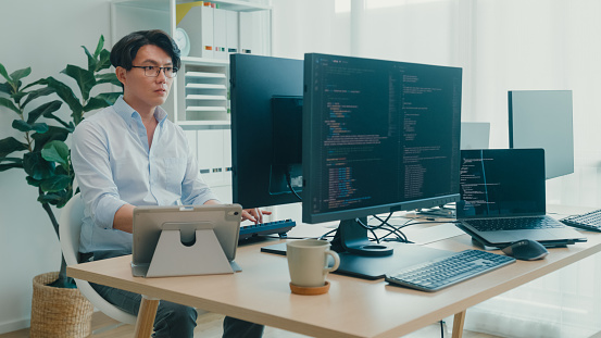 Young Asian Man Software Developers Using Computer To Write Code ...