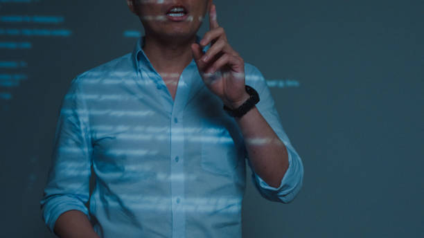 istock Closeup young Asian man software developers mentor leader manager talking to executive team analyzing source code in office at night. Programmer development. 1705601391