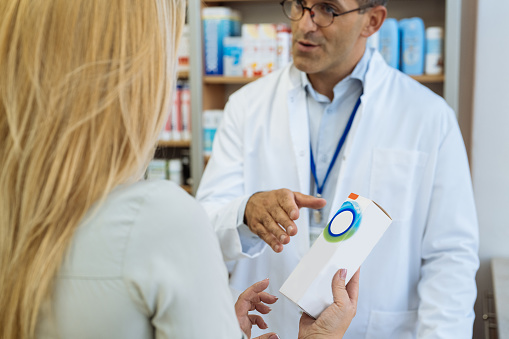 Pharmacist and patient in pharmacy store
