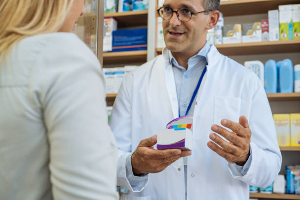 istock Male pharmacist serving customer in pharmacy 1705602946