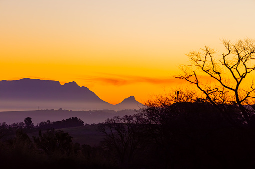 Silhouette of Table Mountain against a dusk sunset sky in Cape Town, South Africa