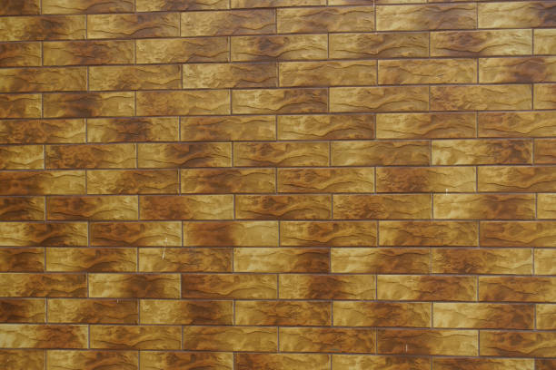 istock Texture of brick like brown embossed ceramic tiles siding 1705626947