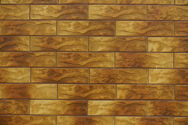 istock Front view of brick like brown embossed ceramic tiles siding 1705626964