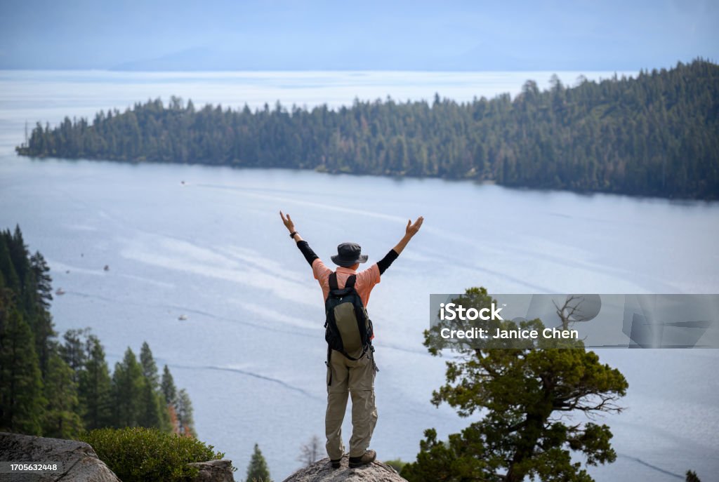Tourist raising arms at Emerald Bay. Lake Tahoe. California. Lake Tahoe Stock Photo