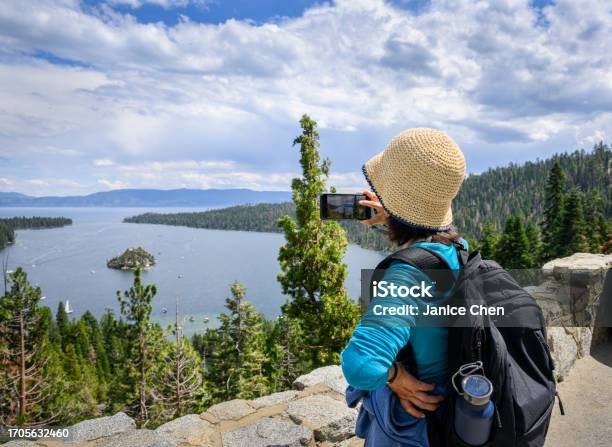 Woman Taking Photos Using Smartphone At The Lookout Emerald Bay Lake Tahoe California Stock Photo - Download Image Now