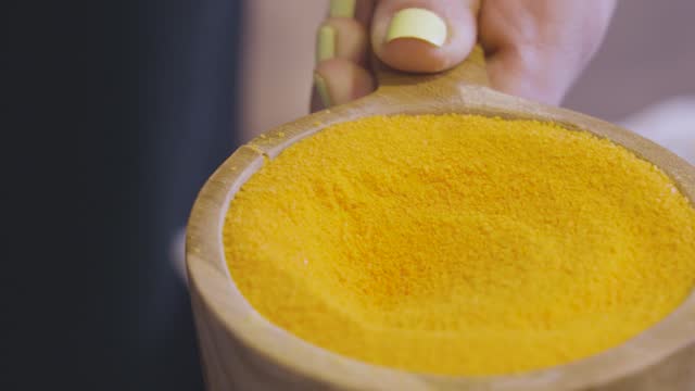 Scooping powder in preperation for a refreshing foot bath at the beauty salon