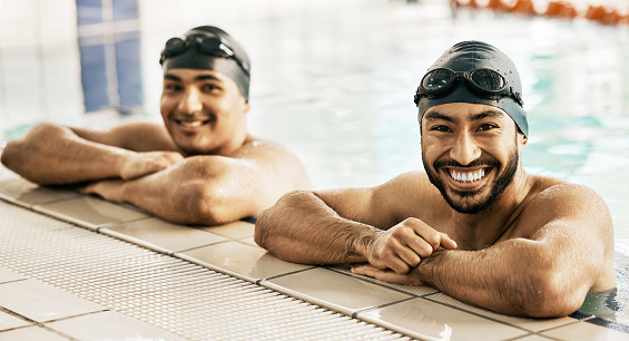 Swimming pool, friends and portrait of men for fitness, exercise and training together in gym. Water sports, professional swimmers and people for workout challenge, teamwork and race competition