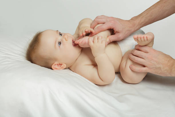 istock Newborn baby in its father hands at home 1705667833