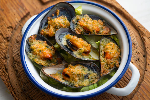 istock Mussels gratin. Gratin seafood dish with bread and parsley. 1705685537