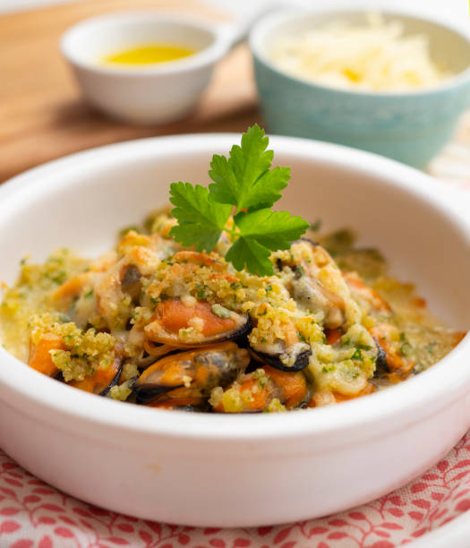 istock Mussels gratin. Gratin seafood dish with bread and parsley. 1705685543