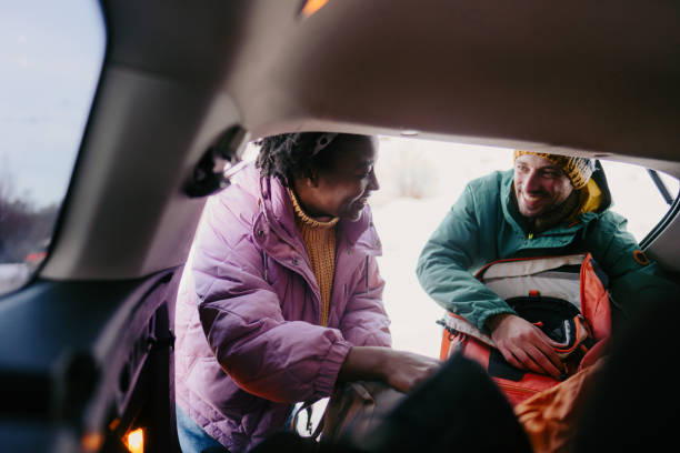 istock Smiling couple preparing for a snowy hike 1705686723