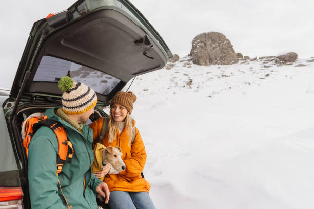 istock Smiling couple preparing for a snowy hike 1705696014