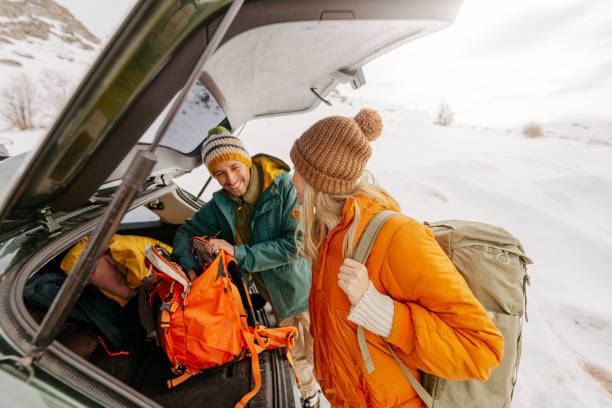 istock Smiling couple preparing for a snowy hike 1705696033