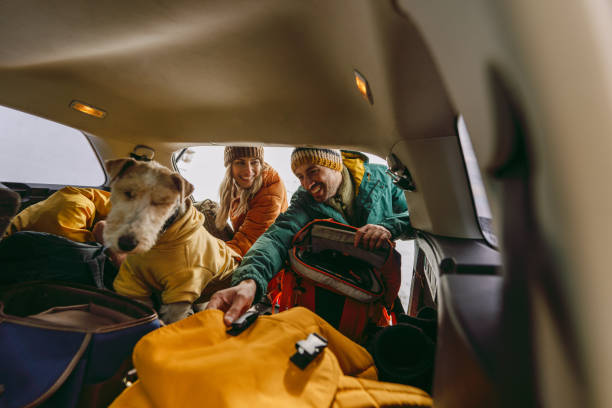 istock Smiling couple preparing for a snowy hike 1705696034
