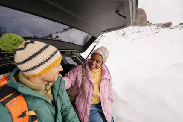 istock Smiling couple preparing for a snowy hike 1705696051