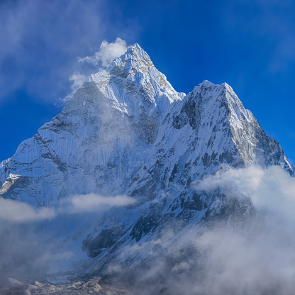 140 MPix XXXXL size panorama of Mount Ama Dablam - probably the most beautiful peak in Himalayas. \n This panoramic landscape is an very high resolution multi-frame composite and is suitable for large scale printing\nAma Dablam is a mountain in the Himalaya range of eastern Nepal. The main peak is 6,812  metres, the lower western peak is 5,563 metres. Ama Dablam means  'Mother's neclace'; the long ridges on each side like the arms of a mother (ama) protecting  her child, and the hanging glacier thought of as the dablam, the traditional double-pendant  containing pictures of the gods, worn by Sherpa women. For several days, Ama Dablam dominates  the eastern sky for anyone trekking to Mount Everest basecamp