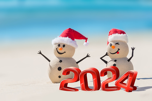 Creative design concept with Sandy Snowmen and 3d numbers on a beautiful beach for the new year