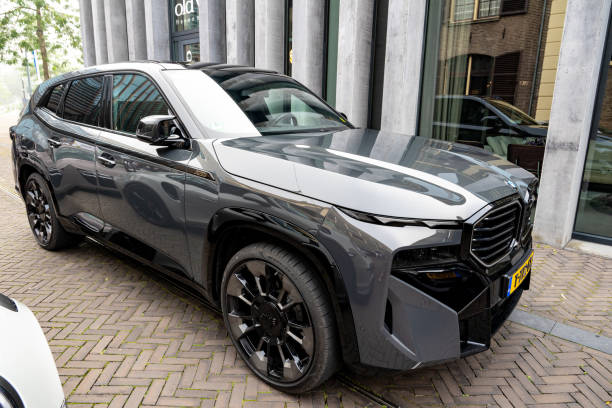 Minsk, Belarus, September 3, 2024 - Front view BMW ix M60 battery-electric mid-size luxury crossover standing near dealership
