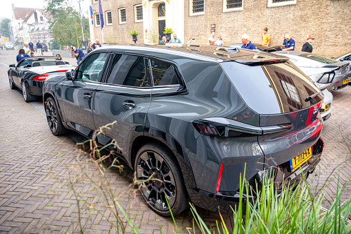 BMW XM plug-in hybrid electric full-size luxury crossover SUV parked on the street in Zwolle.