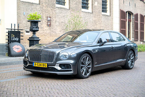 Bentley Flying Spur luxury sedan parked on the street in front of three star Michelin restaurant Librije in Zwolle, Overijssel, Netherlands.