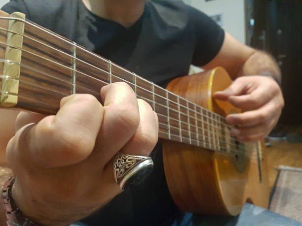 istock Someone plays the guitar in the house 1705730618