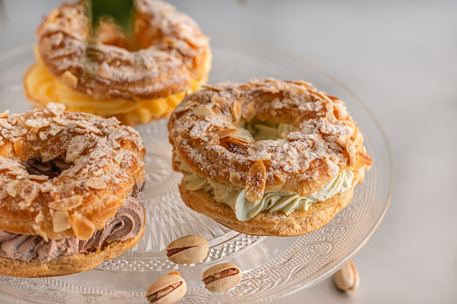 Light puff pastry filled with whipped cream. French dessert made of choux pastry and praline-flavored cream.