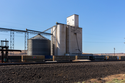 Roosevelt, WA, USA - July 1st, 2023: Farmers Warehouse and Commission Company Industrial buildings and railway