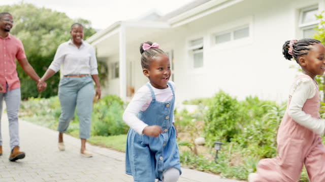 Black family, happy and children running and excited for the weekend leaving their home or house for bonding. Love, people and parents walking with kids playing outdoor a property or real estate
