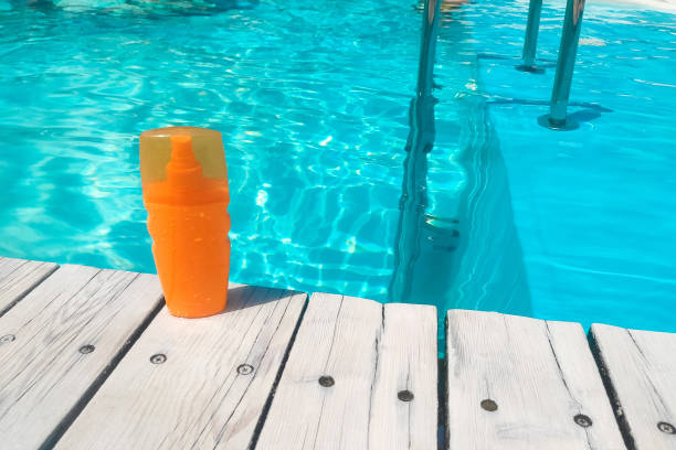 istock Spray sunscreen stands on the background of the pool 1705749151