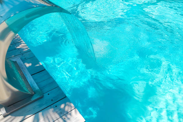 istock Waterfall in the swimming pool with blue water in the background 1705749308