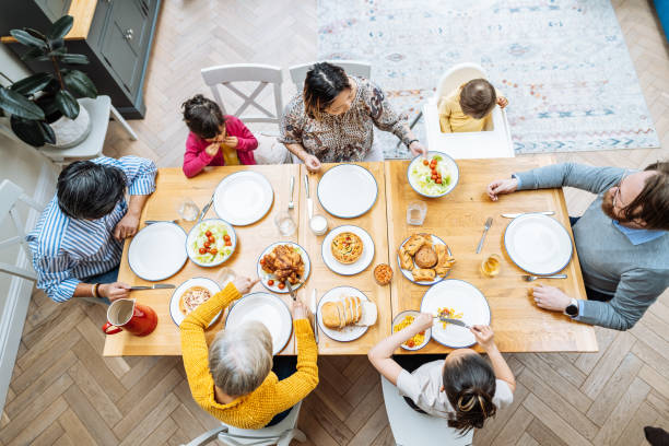 istock Multi-generation Asian family enjoying lunch together at home, high angle view 1705760026