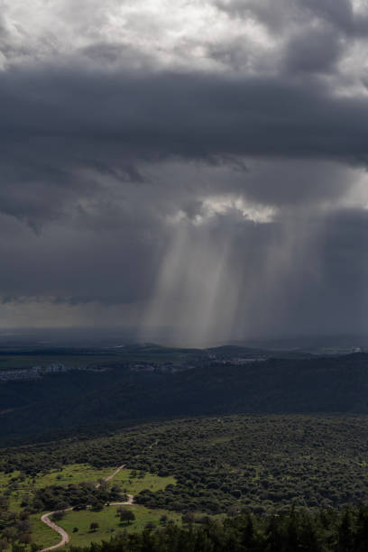 istock Sun rays shining through rainclouds showing the falling rain in Northern Israel looking towards the Mediterranean Sea. 1705773351