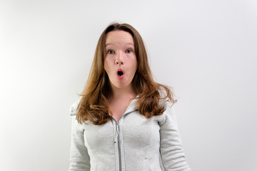 Portrait of a shocked woman with her mouth open. High quality photo