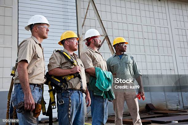 Team Of Construction Workers With Harnesses Stock Photo - Download Image Now - Group Of People, Construction Worker, Manufacturing Occupation