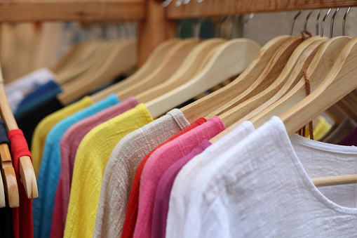 Abundance of various linen shirts on hangers.
