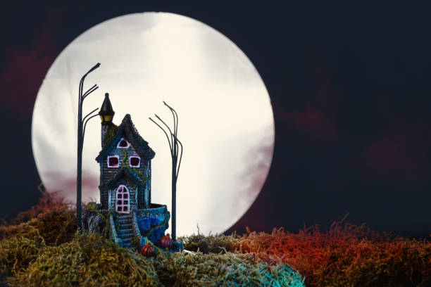 istock Halloween night with haunted house and full moon. 1705793526