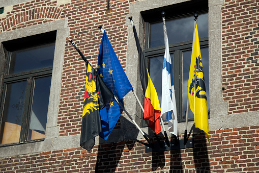 Flags on the old Town Hall in Beersel Dworp in Belgium.