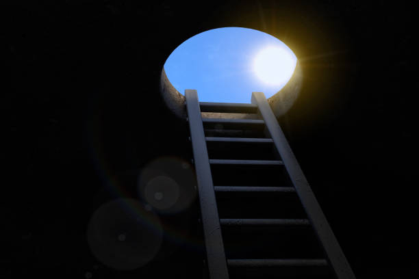 freedom concept. ladder. view from the underground to the ladder and through the manhole with sun. 3d rendering - business slave imagens e fotografias de stock