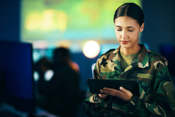 istock Military, woman and working with tablet in surveillance, control room or technical support for army, officer or mission. USA, cybersecurity and person with online database, research or communication 1705802924