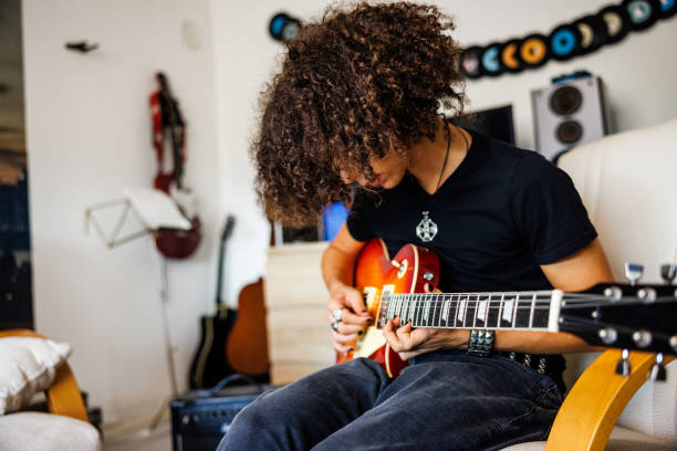 istock Boy practice solo on electric guitar 1705803319