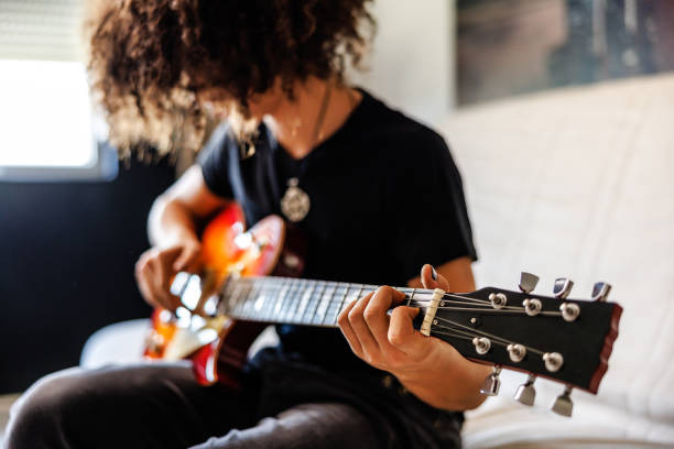 istock Teenage boy play guitar 1705803320