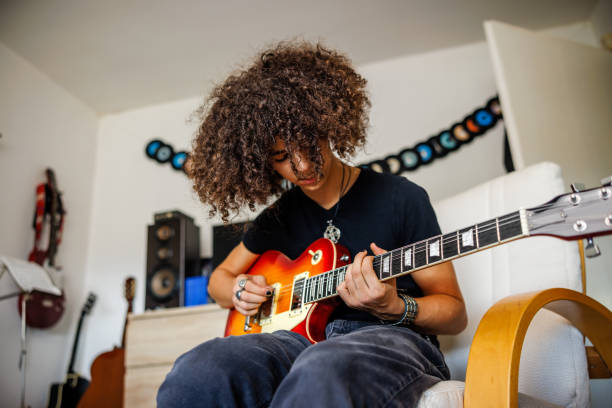 istock Young musician practice guitar 1705803410