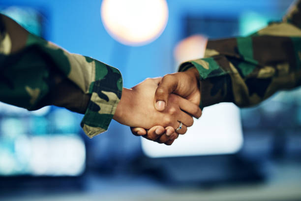 istock Military, army or shaking hands for partnership, teamwork or deal in war, agreement or unity together. People, soldiers or handshake for team fight, thank you or gratitude in solidarity for a mission 1705803690