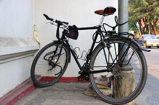 Close-up: An old vintage bicycle parked against the wall.