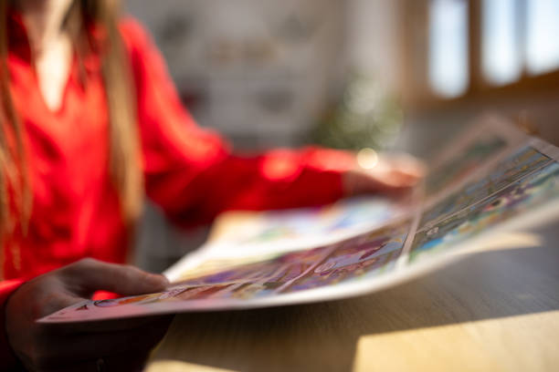 Woman reading a comic book at home