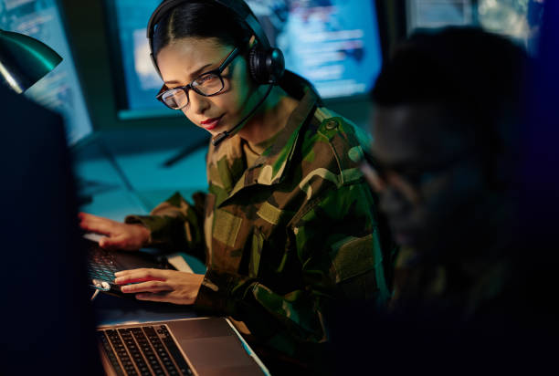 istock Military control room team, headset and woman with computer and tech for communication. Security, global surveillance info and soldier thinking in army office at government cyber data command center. 1705832694